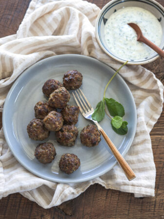 Middle eastern meatballs are served with mint yogurt dip