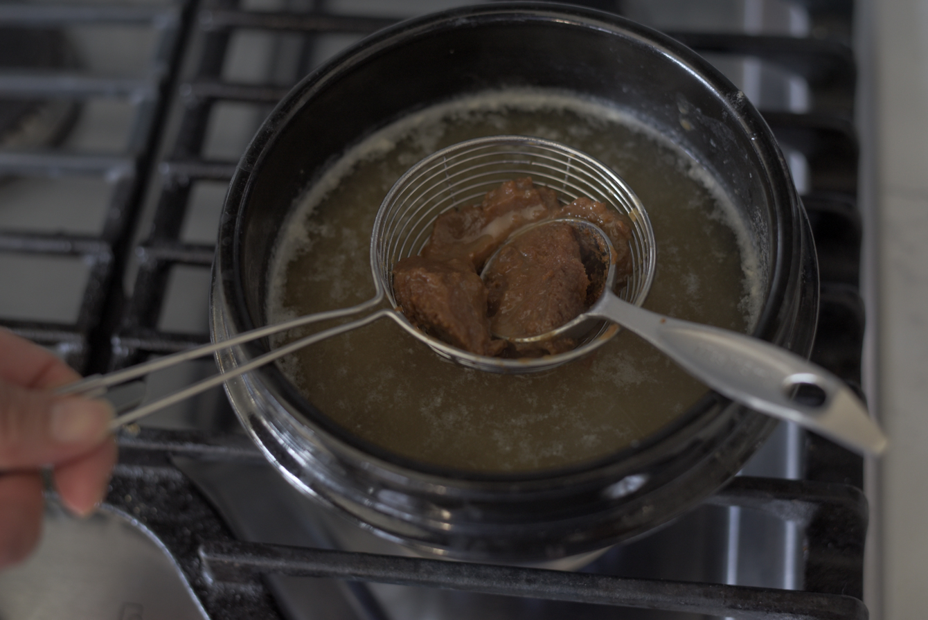 Doenjang being dissolved into anchovy and rice water brothae