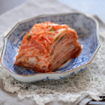 Beautifully sliced cabbage kimchi is served in a dish