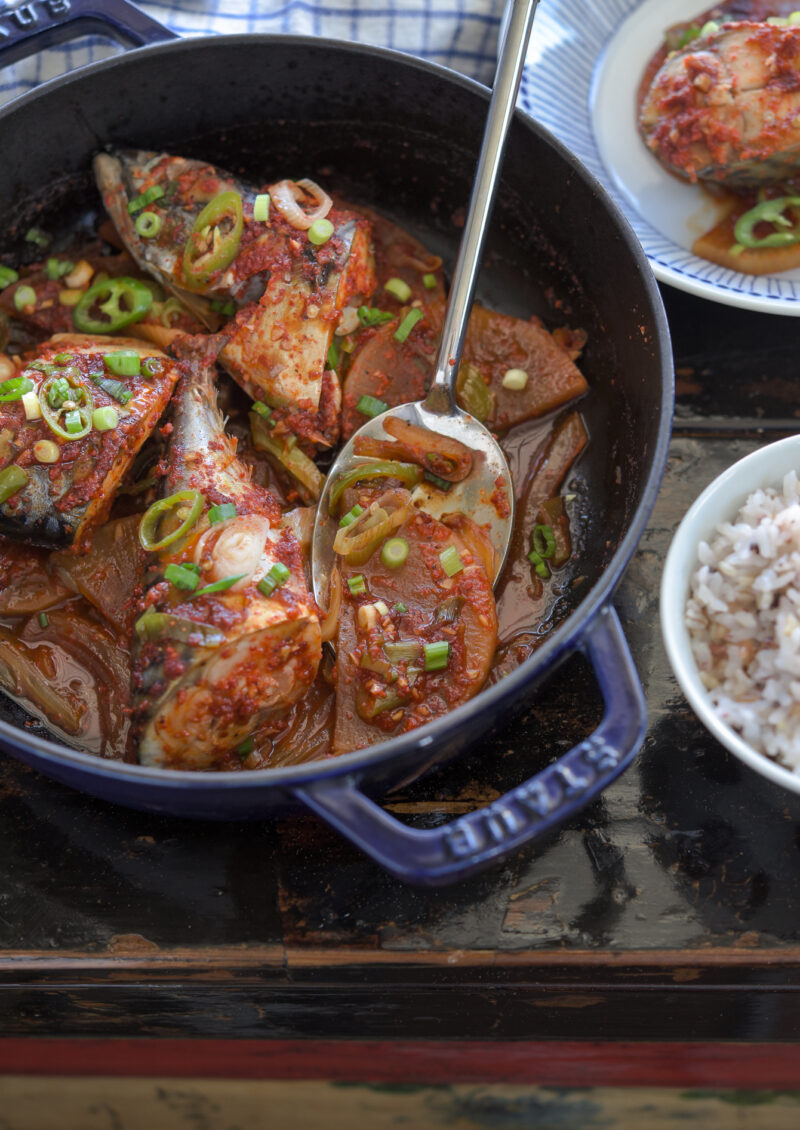 Fresh mackerel fish is braised with  radish in a Korean chili sauce