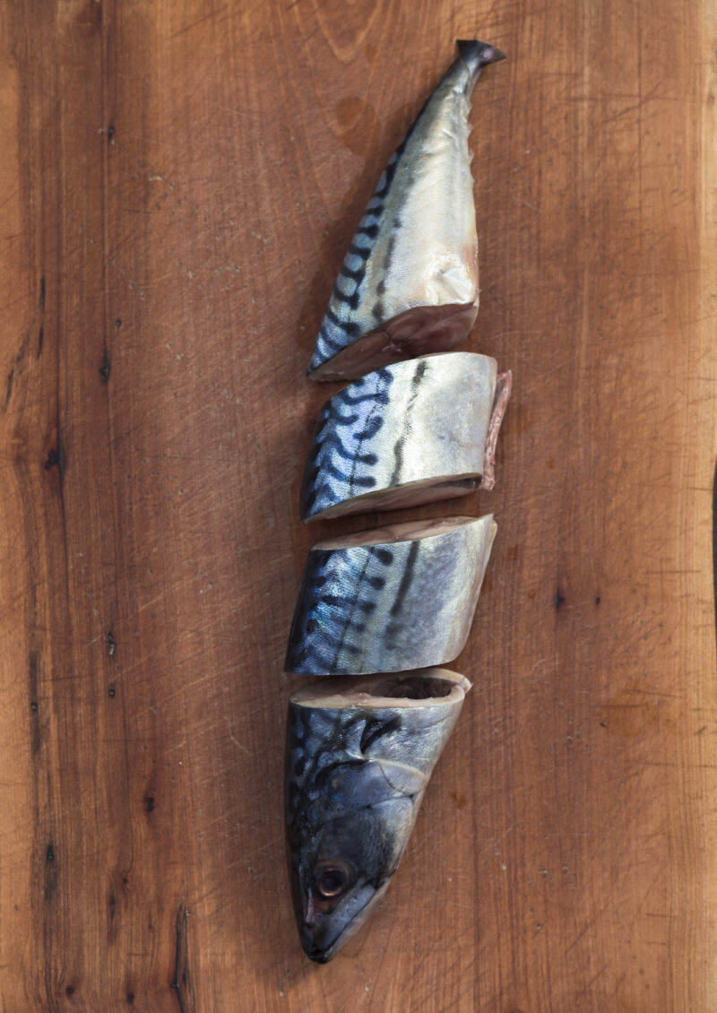 A whole mackerel is sliced into 4 pieces.