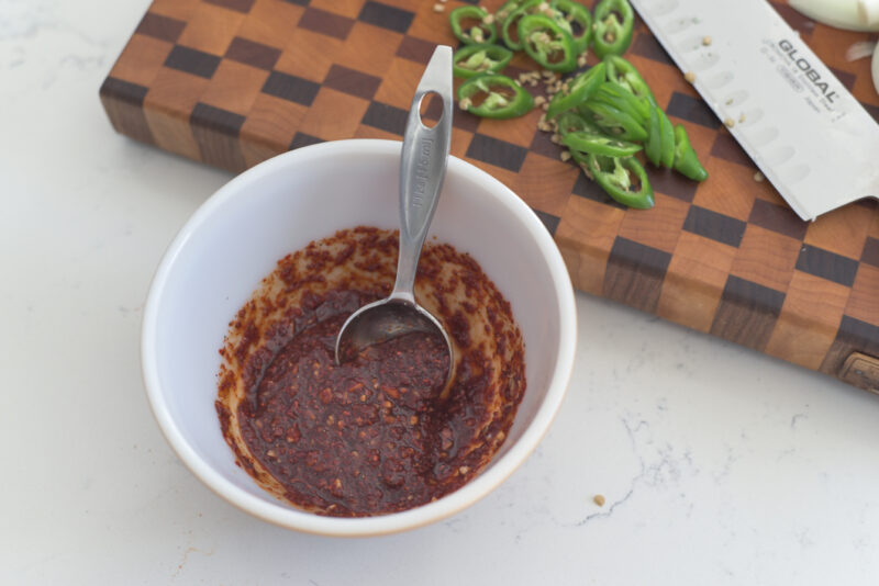 Spicy Korean chili sauce are made in a small bowl.