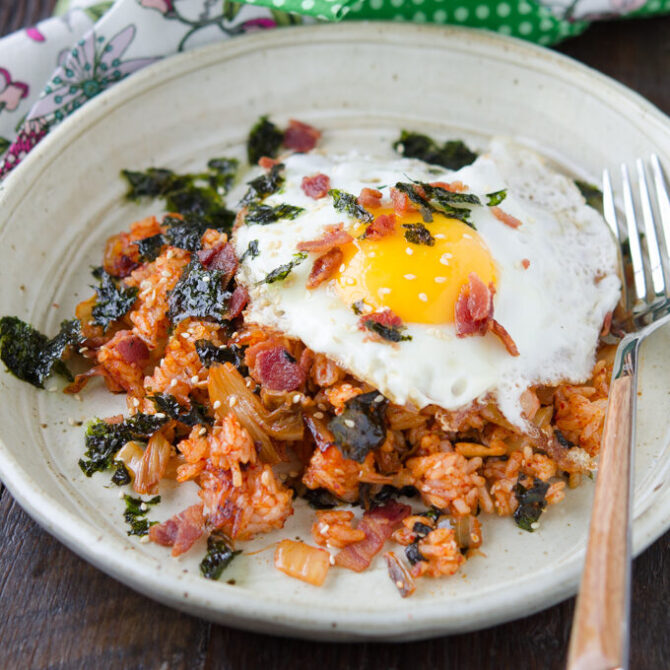 Bacon Kimchi Fried Rice is topped with a fried egg and seaweed.