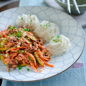 Spicy Korean style sea snail salad is made with canned sea snail and vegetables. Serve with cold vermicelli noodles.