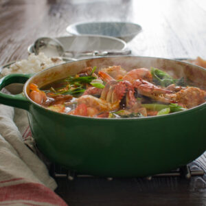 Korean Crab Stew made with fresh crabs and shrimp is steaming hot in a pot.