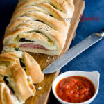 Homemade Stromboli is made with a refrigerated pizza dough and served with marinara sauce.