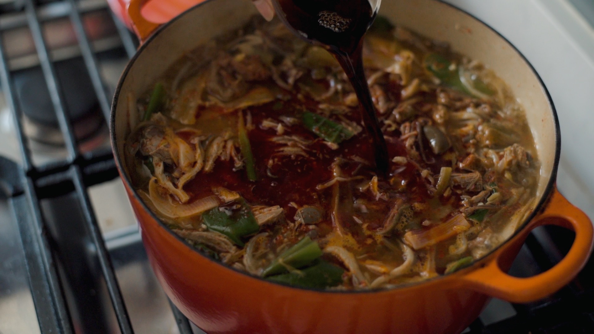 Adding Korean soup soy sauce (gukganjang) and anchovy sauce to season yukgaejang
