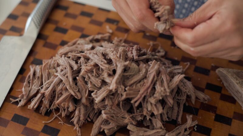 Beef brisket is shredded by hand.