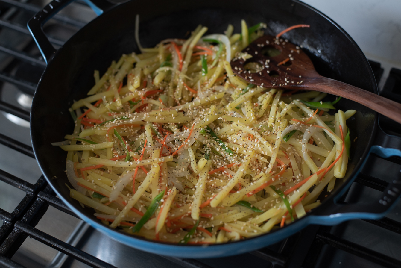 Toasted sesame seeds added to Korean potato side dish