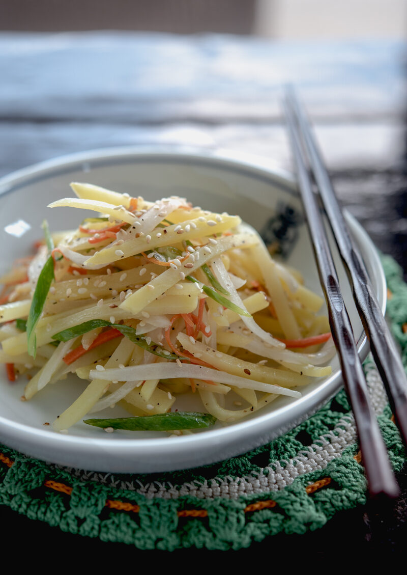 Korean side dish made with strips of potatoes and vegetables