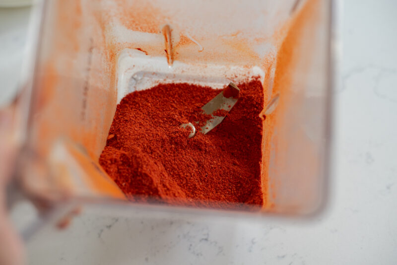 Korean chili flakes processed in a blender to turn into fine chili powder.