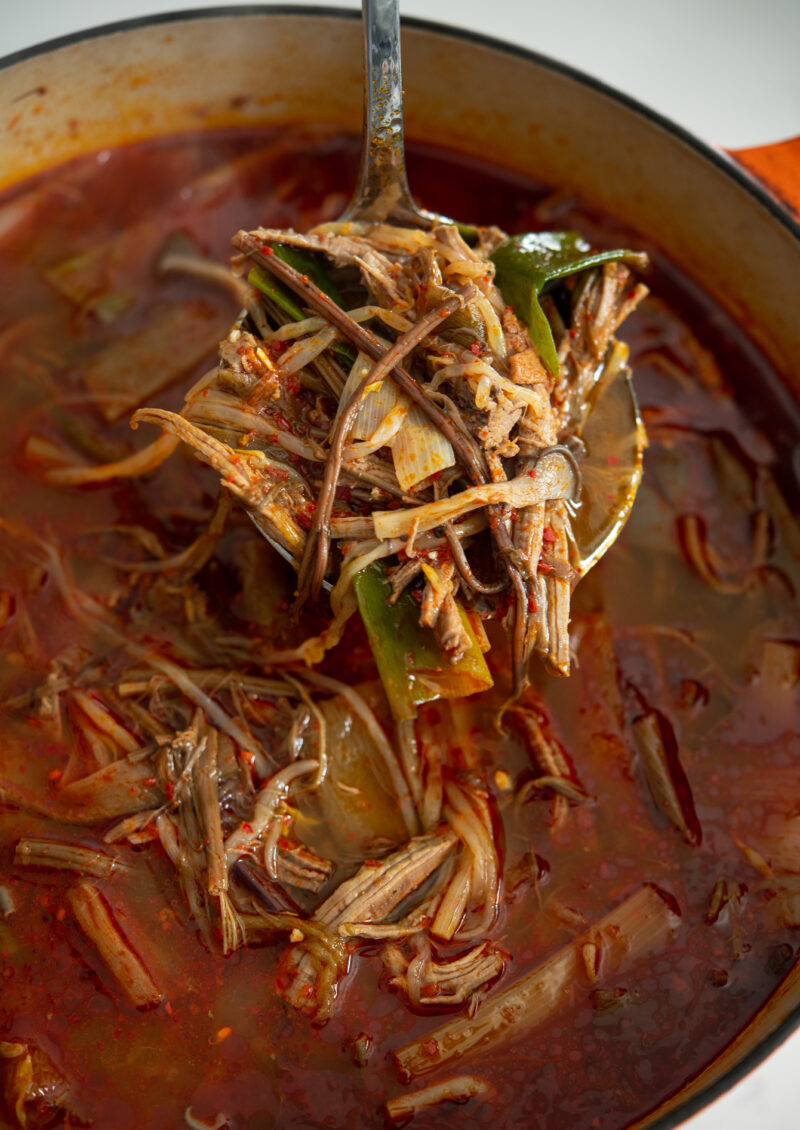 Homemade Korean spicy beef soup (Yukgaejang) with mushroom, mung bean sprouts, and leek