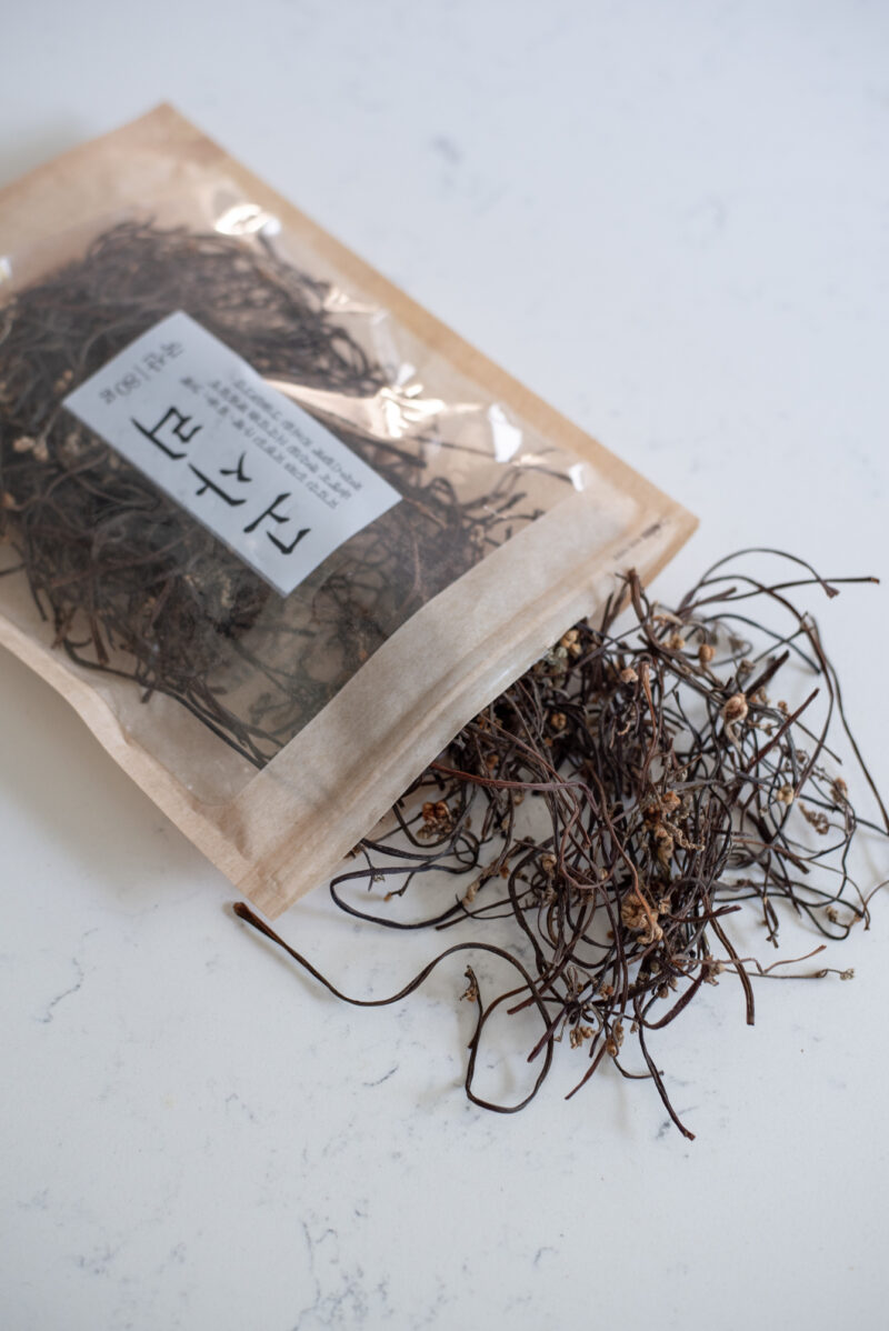 A package of dried fernbrak is opened and showing the content inside on the counter..