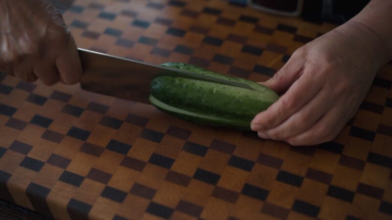 Kirby cucumber in a cross pattern with a knife.