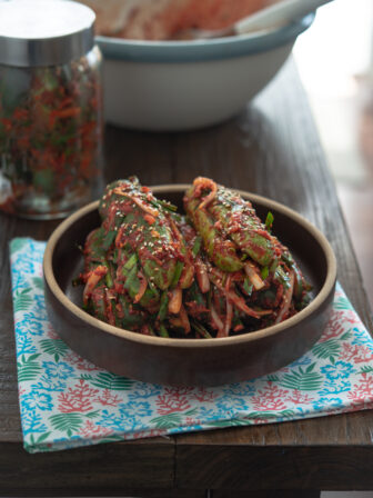 Traditional Korean stuffed cucumber kimchi (Oi-Sobagi) is served in a stone bowl.