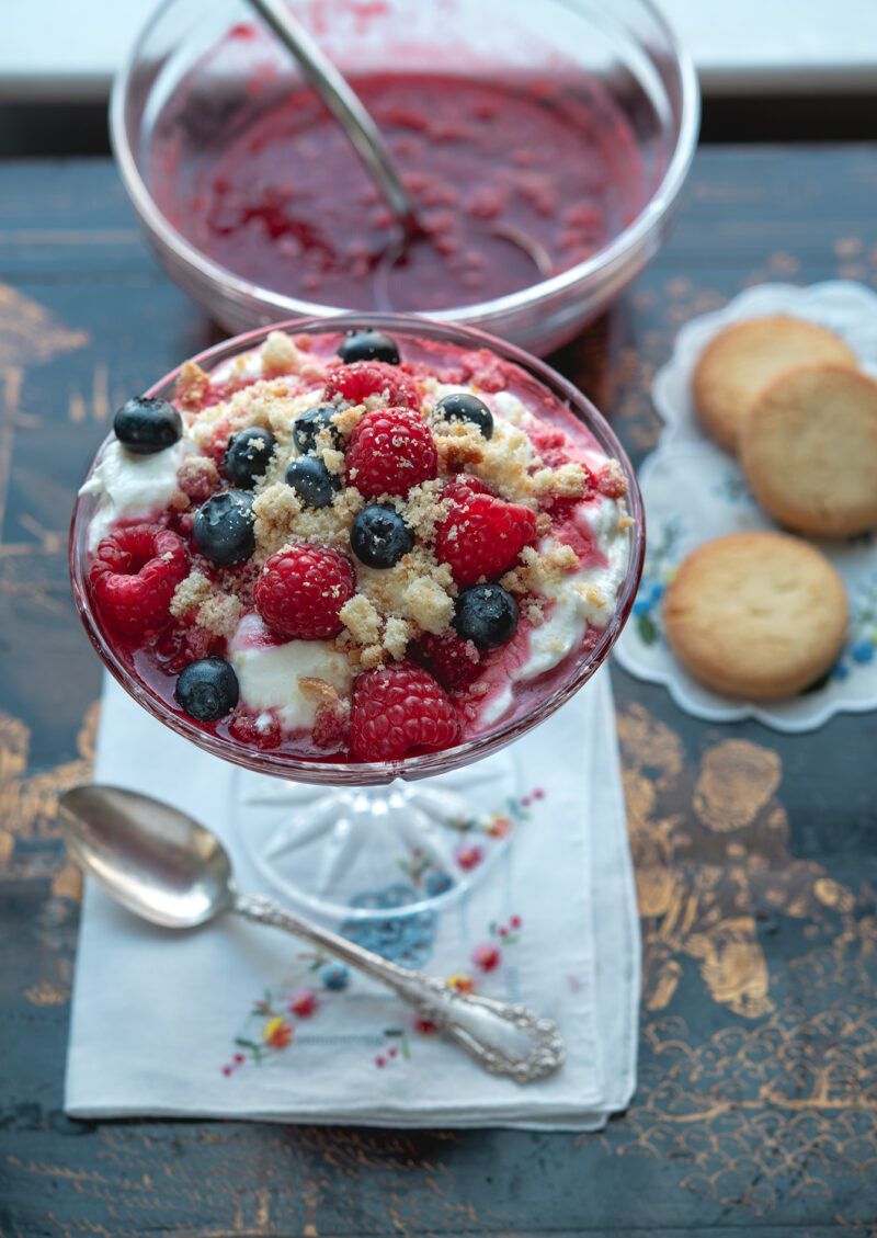 Raspberry fool is a simple raspberries and cream dessert topped with shortbread cooki crumbs