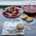 Raspberries and cream topped with shortbread cookie crumbs.