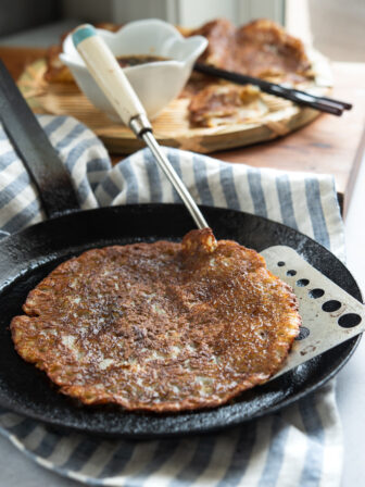 Korean potato pancakes are pan-fried to golden crisp in a skillet