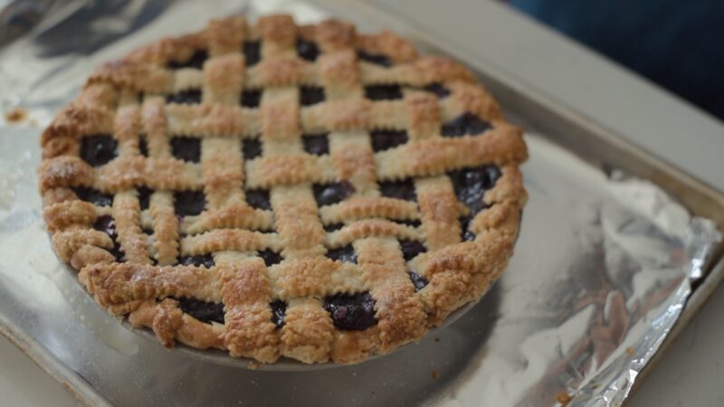 Maple blueberry pie crust is finished baking and showing the golden brown crust.