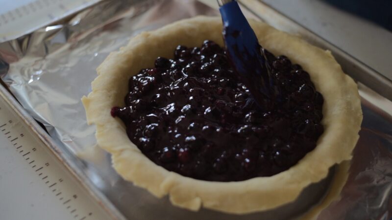 Maple blueberry pie filling is added to a prepared pie crust.