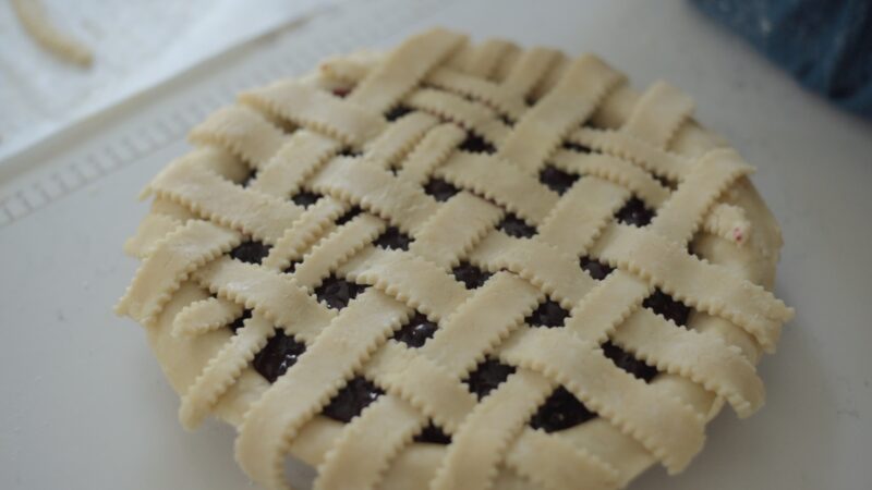 Top crust for blueberry pie is showing its beautiful lattice work.