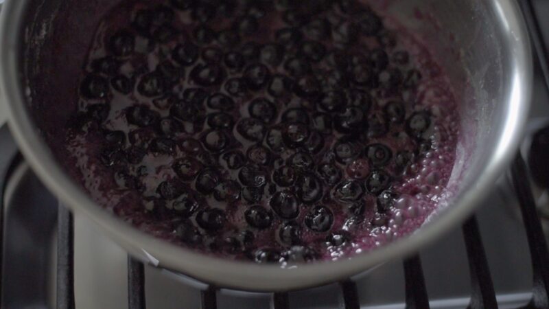 Maple blueberry pie filling is boiling in a pot.