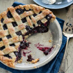 Maple blueberry pie with lattice top crust is cut and served