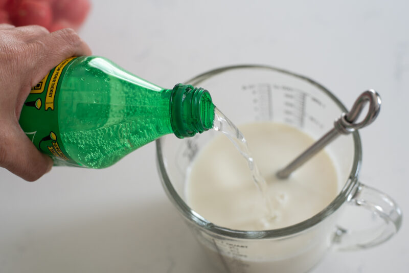 Adding lemon-lime soda to milk honey mixture for making Korean watermelon punch.