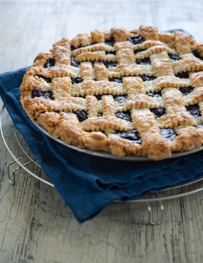 Maple blueberry pie is adorned with lattice top pie crust.