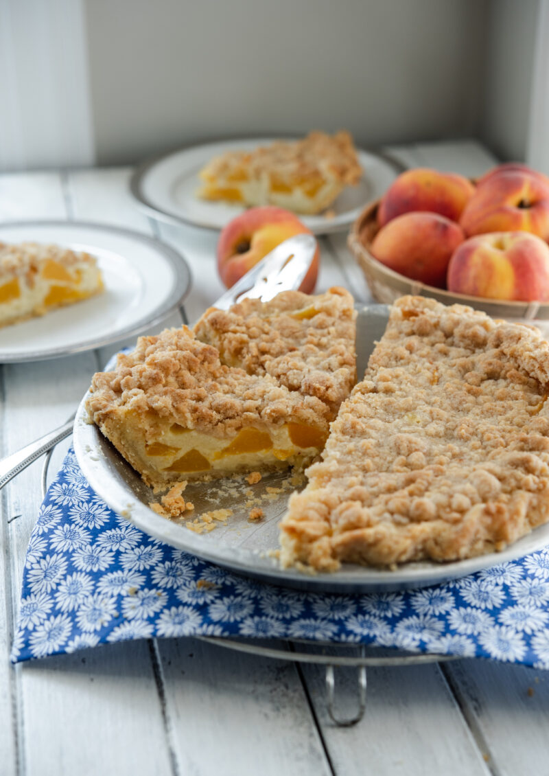 Peach custard pie sliced in a pie tin.