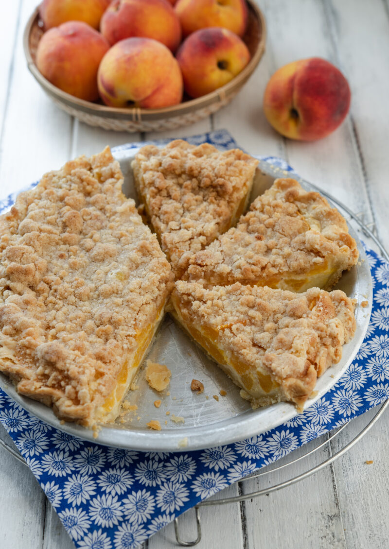 Fresh peach, custard, and streusel combination makes a exceptionally delicious pie.