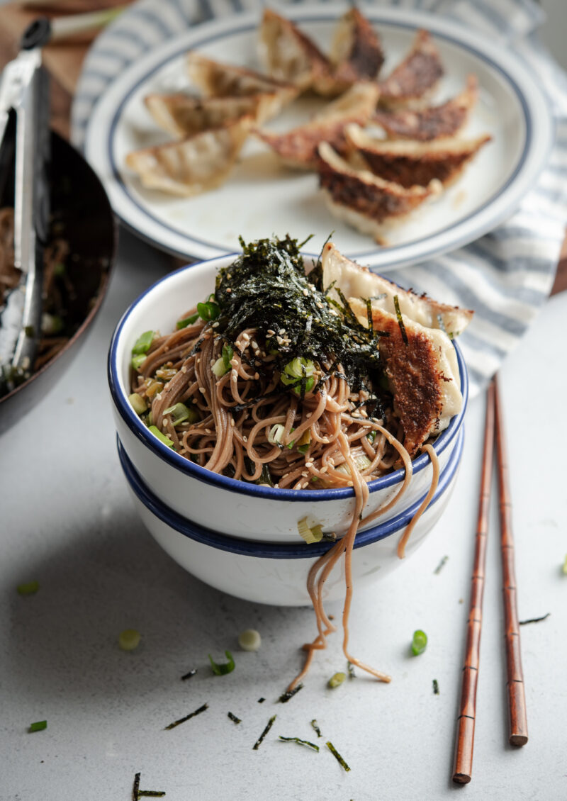 Quick sesame soba noodles topped with crumbled seaweed and fried dumplings
