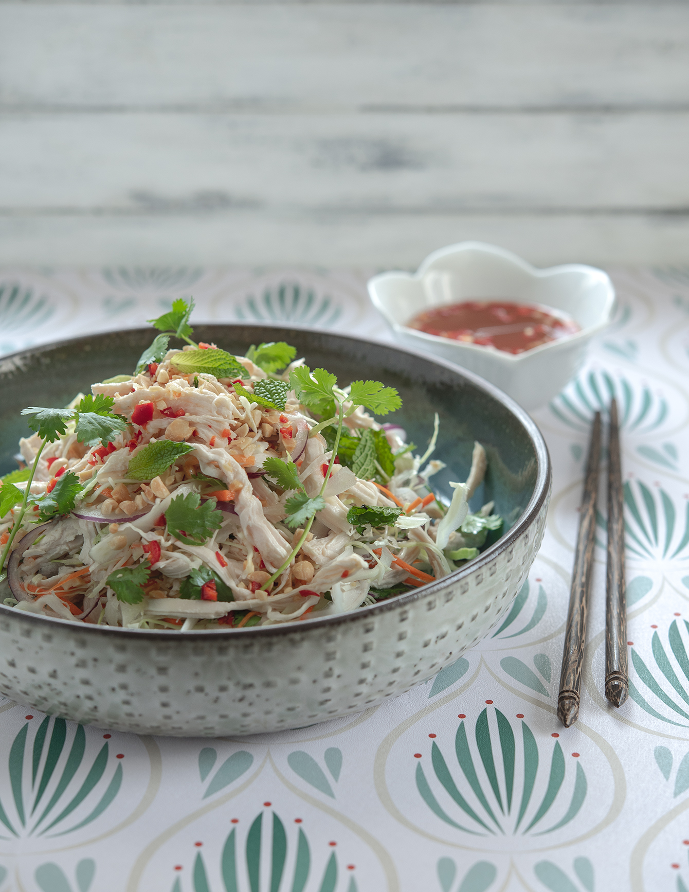 Plated Vietnamese chicken salad topped with fresh cilantro and mint