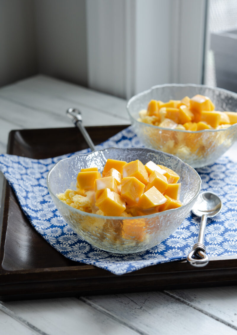 Homemade mango shaved ice (mango bingsu) topped with fresh mango pieces.