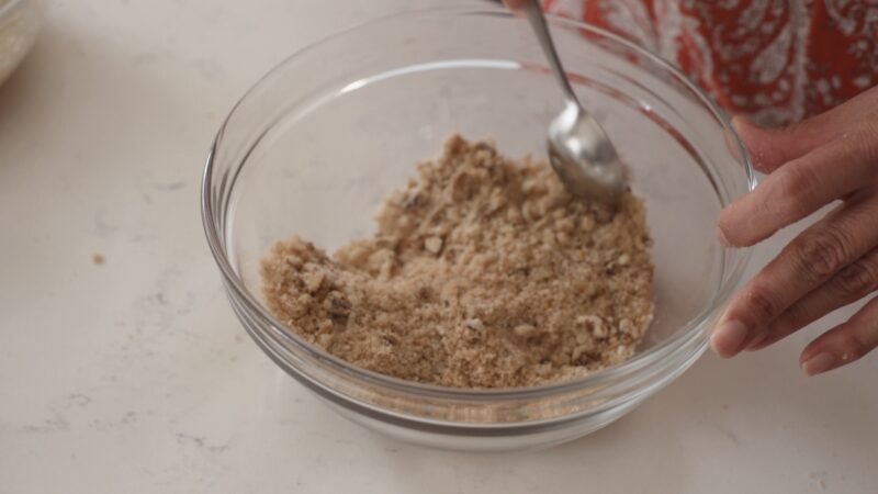 Breadcrumb and walnut are mixed in a bowl.