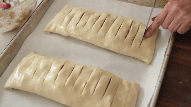 Slits on the apple strudel puff pastry to escape the steam.