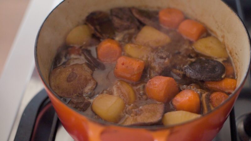 Korean beef short ribs and vegetables are simmering in a pot.