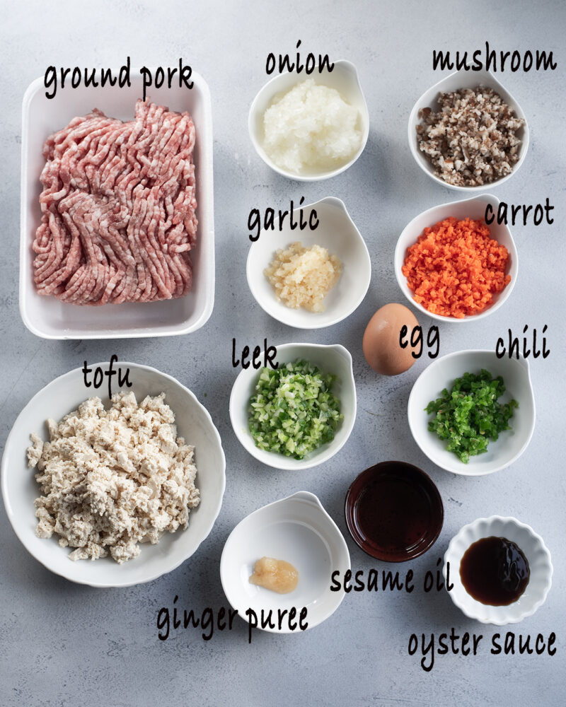 Ingredients for Korean meat tofu patties are placed in bowls.