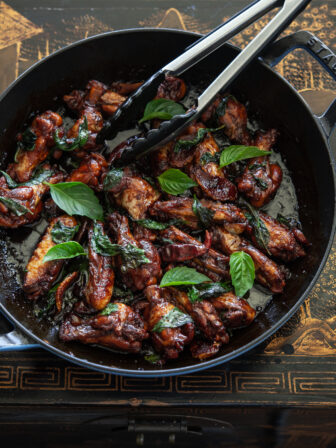 Taiwanese three cup chicken (san bei ji) is garnished with Thai basil leaves.