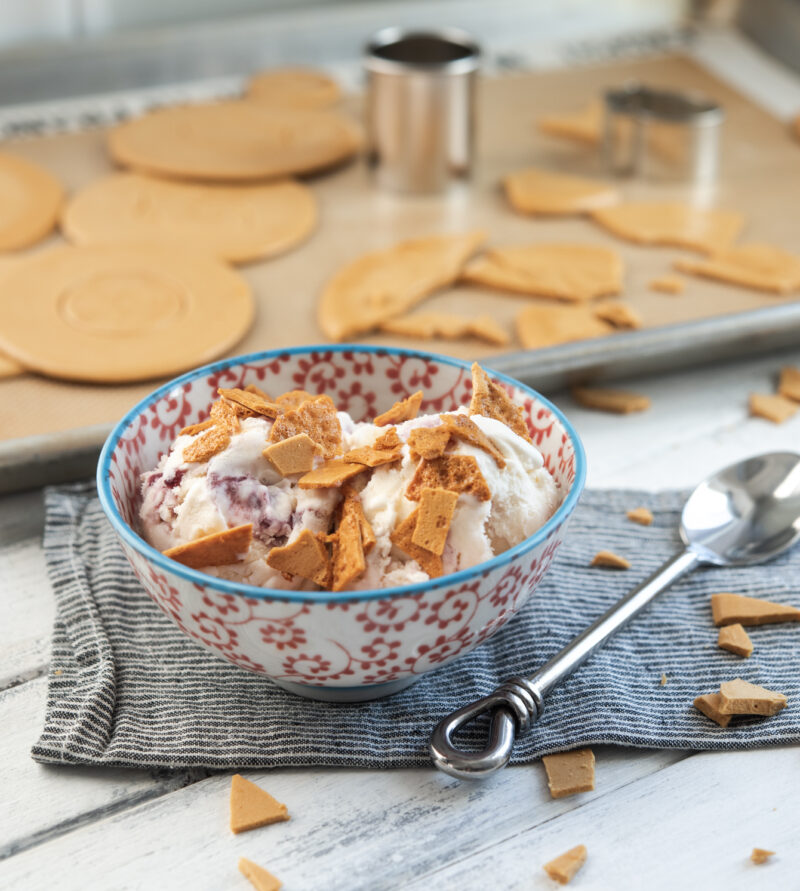 Dalgona candy is broken to small pieces and used as a topping for ice cream.