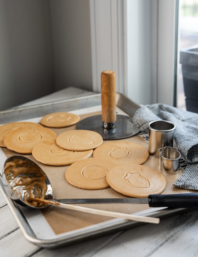 Dalgona, Korean sugar candy, and a soup ladle are shown with cookie cutters.