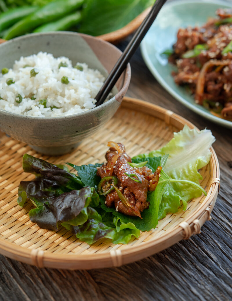 Korean spicy pork (pork bulgogi or jeyuk bokkeum) with a lettuce wrap and rice.