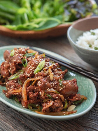 Spicy pork bulgogi glazed in gochujang sauce with sesame seeds and green onion