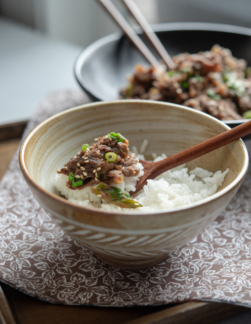 A spoonful of rice is topped with bulgogi
