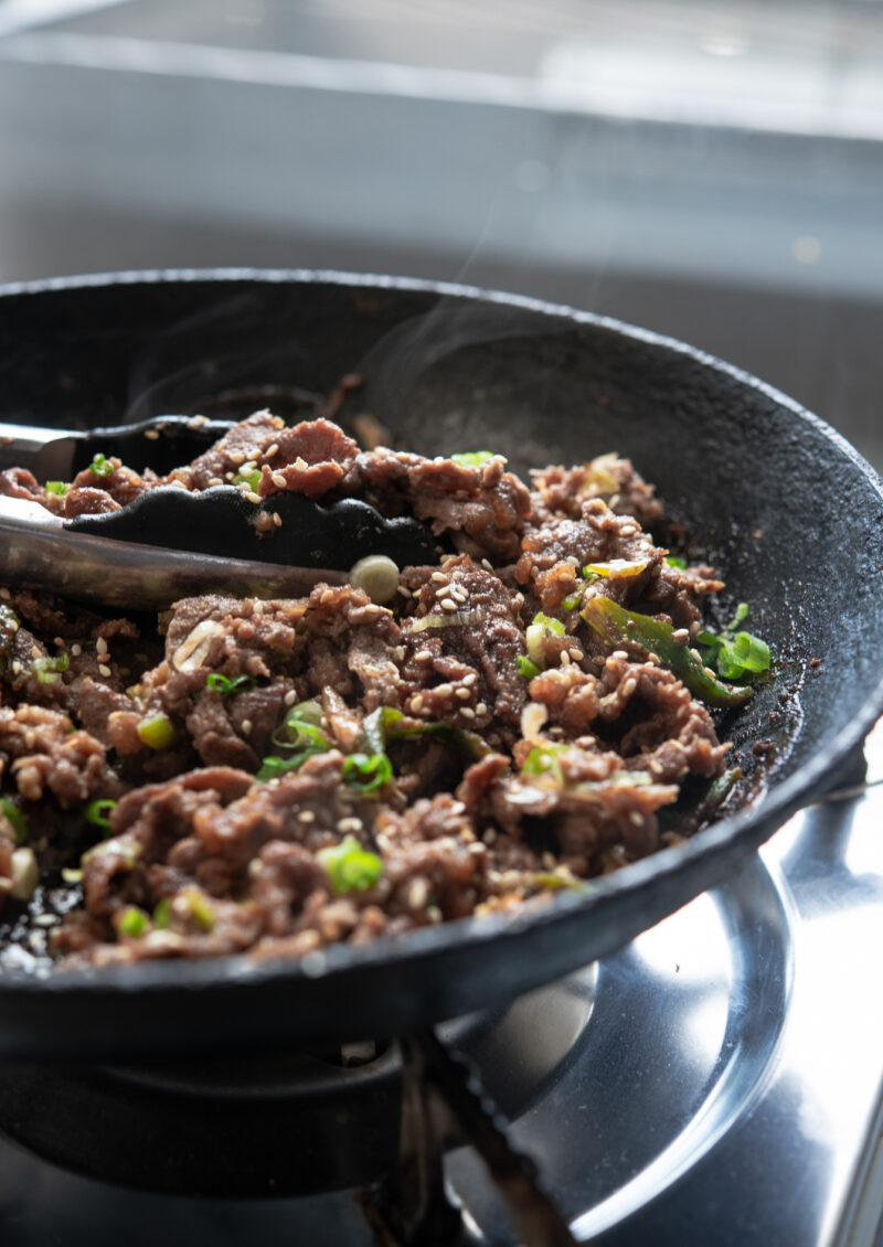 Korean beef bulgogi is cooked in a skillet to a perfection