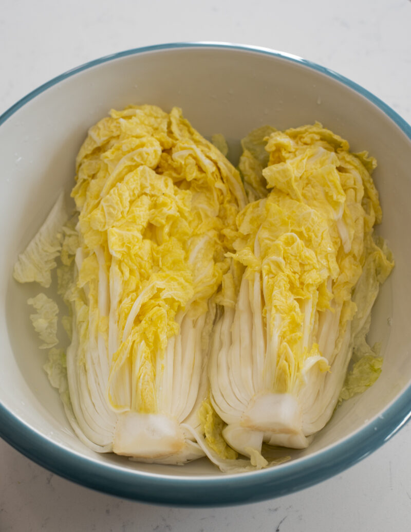 Salt brined cabbage are showing their wilted terxture in the bowl