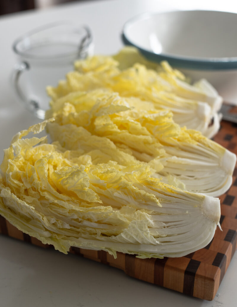 Quartered cabbage pieces with their yellow leaves inside.