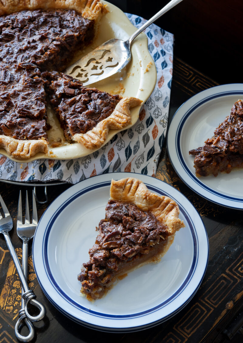 Slices of butterscotch pecan pie pieces are served on dessert plates