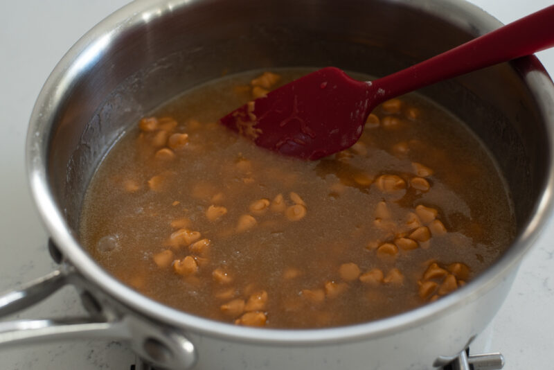 Butterscotch chips are added to melted brown sugar syrup mixture.