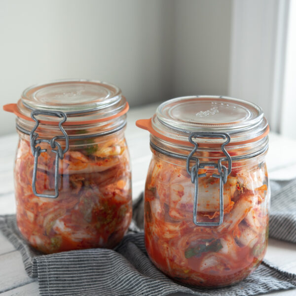 Easy cabbage kimchi (Mak-kimchi) is fermenting in two glass jars